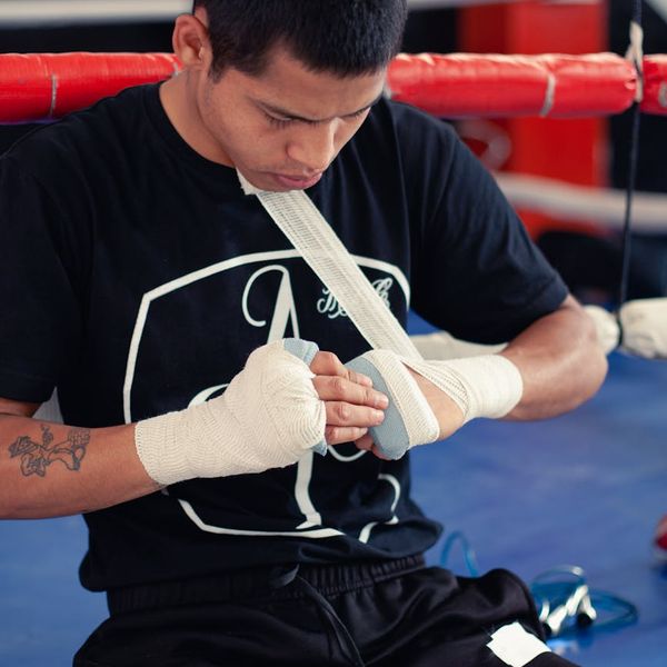 A focused man in athletic wear preparing for a workout session.